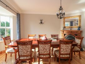 A dining room with a wooden table and chairs at The Lodge Bolinahaney Bunclody, County Wexford