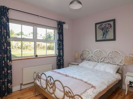 A bedroom with a bed and window at The Lodge Bolinahaney Bunclody, County Wexford