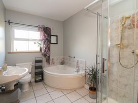 A bathroom with a bathtub, sink, toilet, and shower at The Lodge Bolinahaney in Bunclody, County Wexford