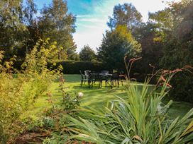 A garden with a table and chairs at The Lodge Bolinahaney in Bunclody, County Wexford