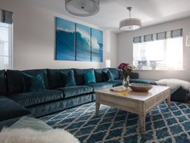 A living room with a sofa and coffee table at Polview in Newquay
