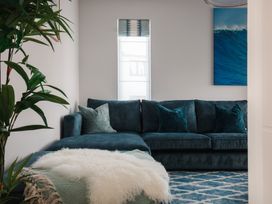 A living room with a sofa and cushions at Polview in Newquay