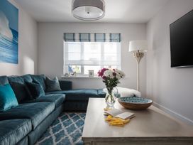 A living room with a sofa and coffee table at Polview in Newquay