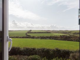 A view of fields and clouds from a window at Polview in Newquay