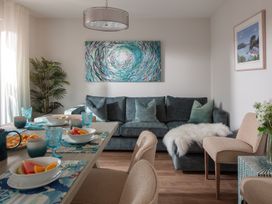 A dining room with a table and sofa at Polview in Newquay