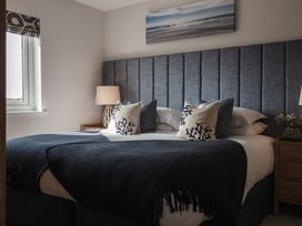A bedroom with a bed and bedside lamp at Polview in Newquay