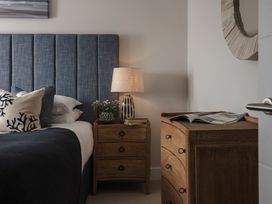 A bedroom with a bed and nightstand at Polview in Newquay