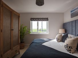 A bedroom with a bed and wardrobe at Polview in Newquay