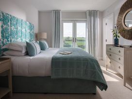 A bedroom with a bed and view at Polview in Newquay
