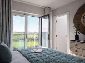 A bedroom with a bed and a book on a quilt at Polview in Newquay