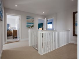 A hallway with staircase and doors at Polview in Newquay