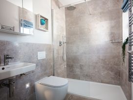 A bathroom with a sink, toilet, and shower at Polview in Newquay
