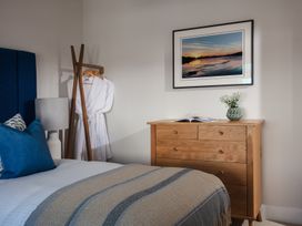 A bedroom with a bed and dresser at Polview in Newquay
