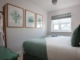 A bedroom with wall art and a bed at Polview in Newquay