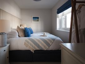 A bedroom with a bed and nightstand at Polview in Newquay