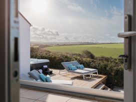 An outdoor area with loungers and a hot tub at Polview in Newquay