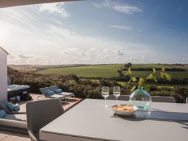 An outdoor dining area with a table and glasses at Polview in Newquay