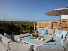 An outdoor area with seating and a table at Polview in Newquay