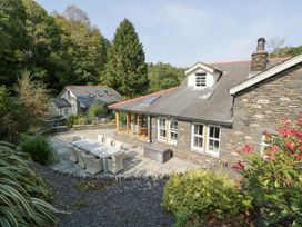 An outdoor space with a patio and dining set at Bobbin Mill Cottage in Ulverston