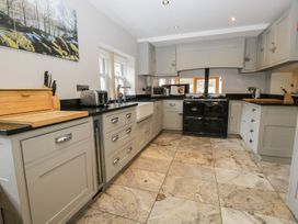 A kitchen with cabinets and stove at Bobbin Mill Cottage in Ulverston