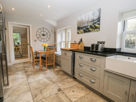 A kitchen with a dining table and chairs at Bobbin Mill Cottage in Ulverston