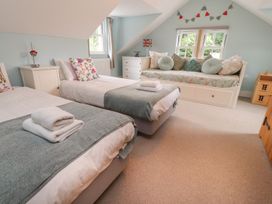 A bedroom with two beds and a day bed at Bobbin Mill Cottage in Ulverston