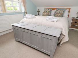 A bedroom with a bed and a storage chest at Bobbin Mill Cottage in Ulverston