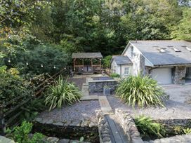 An outdoor area with a gazebo and stone pathway at Bobbin Mill Cottage in Ulverston