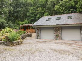 A garage with two doors and a gazebo in an outdoor area at Bobbin Mill Cottage, Ulverston