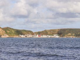 A view of a coastal village and hills at Gelli - Morfa Nefyn