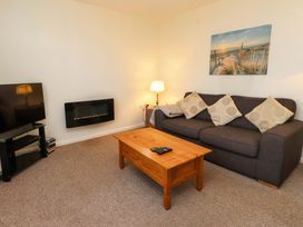 A living room with a sofa and television at Gelli - Morfa Nefyn Morfa Nefyn