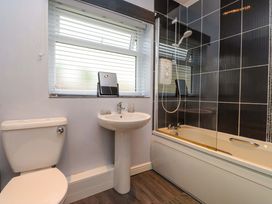 A bathroom with a toilet, sink, and bathtub at Gelli - Morfa Nefyn in Morfa Nefyn