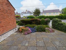 A garden with flowers and pavement at Gelli - Morfa Nefyn, Morfa Nefyn