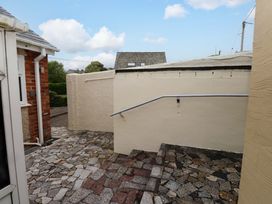An outdoor area with a stone pathway and a handrail at Gelli - Morfa Nefyn, Morfa Nefyn