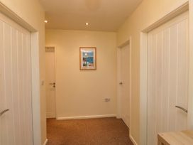 A hallway with doors and a picture frame at Gelli - Morfa Nefyn in Morfa Nefyn