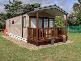 A caravan with a deck and planters at Stag Lodge, Caravan 70 Great Yarmouth