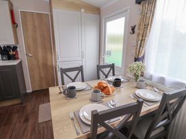 A dining room with a table set for breakfast at Stag Lodge, Caravan 70 Great Yarmouth