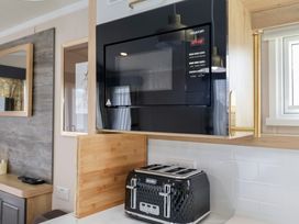 A kitchen with a microwave and toaster at Stag Lodge, Caravan 70 Great Yarmouth