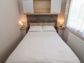 A bedroom with a bed and bedside tables at Stag Lodge, Caravan 70 in Great Yarmouth