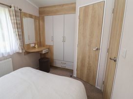 A bedroom with a desk and wardrobe at Stag Lodge, Caravan 70, Great Yarmouth