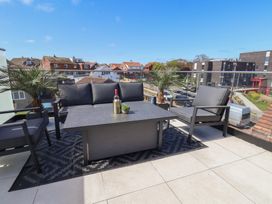 An outdoor seating area with a sofa and table at Falcon Luxe in Whitby
