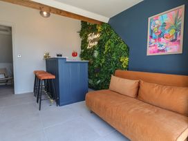 A living room with a bar and neon sign at Falcon Luxe in Whitby