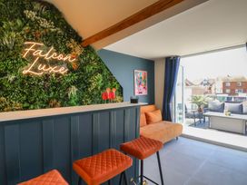 A lounge area with a bar and seating at Falcon Luxe in Whitby