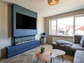 A living room with a television and fireplace at Falcon Luxe in Whitby