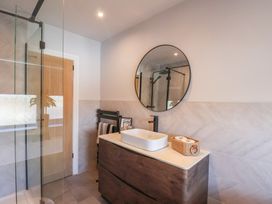 A bathroom with a sink and mirror at Falcon Luxe in Whitby