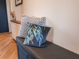 A living room with pillows on a bench at Falcon Luxe in Whitby