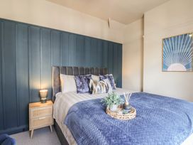A bedroom with a bed and decorative items at Falcon Luxe in Whitby