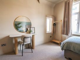 A bedroom with a desk, chair, and bed at Falcon Luxe in Whitby