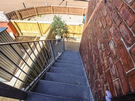 A staircase leading down to a garden area at Falcon Luxe in Whitby