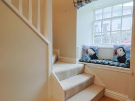 A staircase with a window and cushions at Half Moon Cottage in Lyme Regis